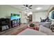 Open-concept living area with a breakfast bar, TV, and a seamless flow throughout at 3229 40Th S Ln # C, St Petersburg, FL 33711