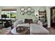Living room featuring a sofa, work space, a large window and modern shelving unit at 3229 40Th S Ln # C, St Petersburg, FL 33711
