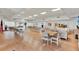 Large community meeting room featuring tables, chairs, and kitchen access for community gatherings at 3229 40Th S Ln # C, St Petersburg, FL 33711