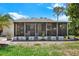 Inviting screened-in porch with lush landscaping providing a tranquil outdoor space at 3229 40Th S Ln # C, St Petersburg, FL 33711