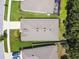 Aerial view of the house, showcasing its roof, landscaping, and surrounding neighborhood at 32825 Sand Creek Dr, Wesley Chapel, FL 33543