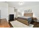 Comfortable bedroom with a wood bed frame, neutral decor, and ample natural light at 32825 Sand Creek Dr, Wesley Chapel, FL 33543