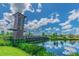 Picturesque community park with a unique bridge and tower, reflecting beautifully in the calm water at 32825 Sand Creek Dr, Wesley Chapel, FL 33543