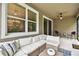 Relaxing covered patio featuring comfortable seating and a ceiling fan, perfect for enjoying the outdoors at 32825 Sand Creek Dr, Wesley Chapel, FL 33543