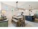 Open floor plan featuring dining room open to the kitchen with stylish lighting and decor at 32825 Sand Creek Dr, Wesley Chapel, FL 33543