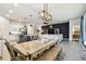 Open concept dining and kitchen area with sleek appliances, granite counters, and stylish décor at 32825 Sand Creek Dr, Wesley Chapel, FL 33543