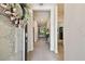 Inviting entryway with a decorative wreath, tile flooring, and views of the living space at 32825 Sand Creek Dr, Wesley Chapel, FL 33543