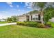 Charming single-story home with a manicured lawn and mature landscaping at 32825 Sand Creek Dr, Wesley Chapel, FL 33543