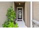 Welcoming front entryway with a decorative wreath and vibrant greenery at 32825 Sand Creek Dr, Wesley Chapel, FL 33543