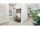 Hallway features decorative bench and leads to bedrooms and living area with stylish decor and natural light at 32825 Sand Creek Dr, Wesley Chapel, FL 33543