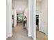 Bright hallway that leads into the living room with a view of the office space at 32825 Sand Creek Dr, Wesley Chapel, FL 33543