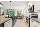 Modern kitchen with granite countertops, stainless steel appliances, and views to the breakfast area at 32825 Sand Creek Dr, Wesley Chapel, FL 33543