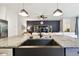 Kitchen island features granite countertops and a farmhouse sink, open to the living space at 32825 Sand Creek Dr, Wesley Chapel, FL 33543