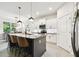 Modern kitchen with gray island, granite countertops, pendant lighting, and stainless appliances at 32825 Sand Creek Dr, Wesley Chapel, FL 33543