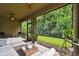 Relaxing screened lanai featuring comfortable seating and views of the serene backyard at 32825 Sand Creek Dr, Wesley Chapel, FL 33543