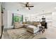Spacious living room open to the kitchen featuring tile floors and a comfortable sectional sofa at 32825 Sand Creek Dr, Wesley Chapel, FL 33543