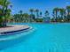 Resort-style community pool featuring a fountain and surrounded by palm trees, perfect for relaxation and recreation at 32825 Sand Creek Dr, Wesley Chapel, FL 33543