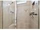 Close up of modern shower featuring gray tile and recessed shelving with glass door at 32825 Sand Creek Dr, Wesley Chapel, FL 33543