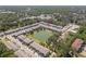 Aerial view of the community showcasing townhomes next to a beautiful pond and mature trees at 3334 Pleasant Willow Ct, Brandon, FL 33511