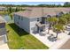 Aerial view of townhomes next to a beautiful pond and mature trees at 3334 Pleasant Willow Ct, Brandon, FL 33511