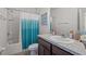 Well-lit bathroom featuring a shower-tub combo, vanity with sink, and storage space at 3334 Pleasant Willow Ct, Brandon, FL 33511