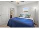 Cozy bedroom with a ceiling fan, bright window, and simple decor at 3334 Pleasant Willow Ct, Brandon, FL 33511