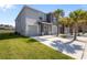 Modern townhome featuring an attached garage, a well-manicured lawn and swaying palm trees at 3334 Pleasant Willow Ct, Brandon, FL 33511