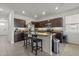 Kitchen featuring an island with granite countertops, dark wood cabinets, and stainless steel appliances at 3334 Pleasant Willow Ct, Brandon, FL 33511