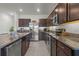 Kitchen with stainless steel appliances, granite countertops, and dark wood cabinets at 3334 Pleasant Willow Ct, Brandon, FL 33511