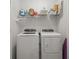 Bright laundry room featuring a full-size washer, dryer, and a convenient overhead storage shelf at 3334 Pleasant Willow Ct, Brandon, FL 33511