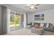 Living room with a ceiling fan, large window, and a sectional sofa at 3334 Pleasant Willow Ct, Brandon, FL 33511