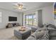 Living room with a ceiling fan, large window, and an ottoman at 3334 Pleasant Willow Ct, Brandon, FL 33511