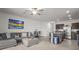 An open floor plan living room with gray sofa, art, breakfast nook, and island seating at 3334 Pleasant Willow Ct, Brandon, FL 33511