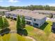 Exterior rear view of townhomes with covered patios, lawn, and pond at 3334 Pleasant Willow Ct, Brandon, FL 33511