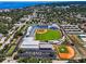 Aerial view of the baseball field, stadiums, surrounding city, and the Gulf of Mexico at 420 Roanoke St, Dunedin, FL 34698