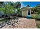 Lush backyard view showcasing a brick paver patio and greenery at 420 Roanoke St, Dunedin, FL 34698