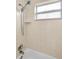 A well-lit bathroom with a shower head and tiles at 420 Roanoke St, Dunedin, FL 34698