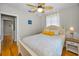 Bedroom with hardwood floors, ceiling fan, closet, and ensuite door at 420 Roanoke St, Dunedin, FL 34698
