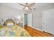 Bedroom featuring a ceiling fan, decorated bed and doorway to the hallway at 420 Roanoke St, Dunedin, FL 34698