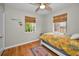 Cozy bedroom featuring bright natural light and beautiful hardwood floors at 420 Roanoke St, Dunedin, FL 34698