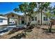 Charming single-story home with a covered carport, well-maintained landscaping, and a walkway to the front door at 420 Roanoke St, Dunedin, FL 34698