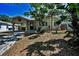 Charming single story home featuring a welcoming porch and lush landscaping at 420 Roanoke St, Dunedin, FL 34698
