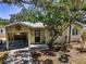 Charming bungalow with shaded front yard, carport, and inviting entrance at 420 Roanoke St, Dunedin, FL 34698