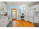 Bright kitchen features white cabinets, wood floors, and a door leading to the pool area at 420 Roanoke St, Dunedin, FL 34698