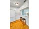 Bright kitchen featuring white cabinets, barstool seating, hardwood floors, and stainless appliances at 420 Roanoke St, Dunedin, FL 34698