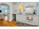 Bright, updated kitchen features white cabinets, hardwood floors, and modern appliances at 420 Roanoke St, Dunedin, FL 34698