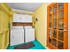 Functional laundry room featuring a washer, dryer, and bright cabinets, providing convenience and organization at 420 Roanoke St, Dunedin, FL 34698