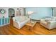Comfortable living area featuring a plush sofa, hardwood floors, and bright decor at 420 Roanoke St, Dunedin, FL 34698