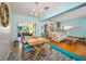 A charming living and dining area featuring colorful accents and abundant natural light at 420 Roanoke St, Dunedin, FL 34698