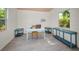 Studio interior showcasing plank floors, multiple tables, and an air conditioner at 420 Roanoke St, Dunedin, FL 34698